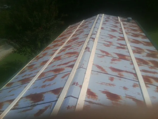 Rusted metal roof panels with new wood purlins before replacement — Storm Damage Roof Repair in Bolinas by Roofing Brothers