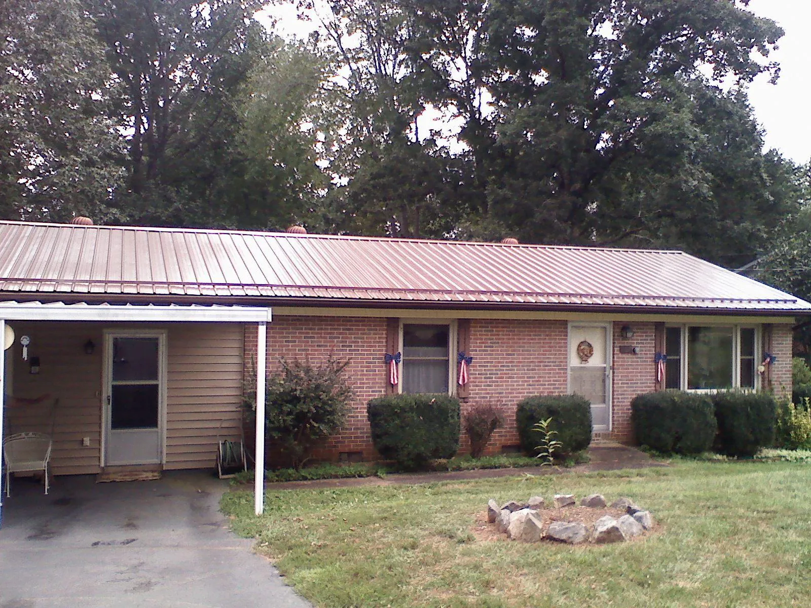 Bronze metal roof and carport on a brick ranch home — Roof Repair work by our crew in Bolinas